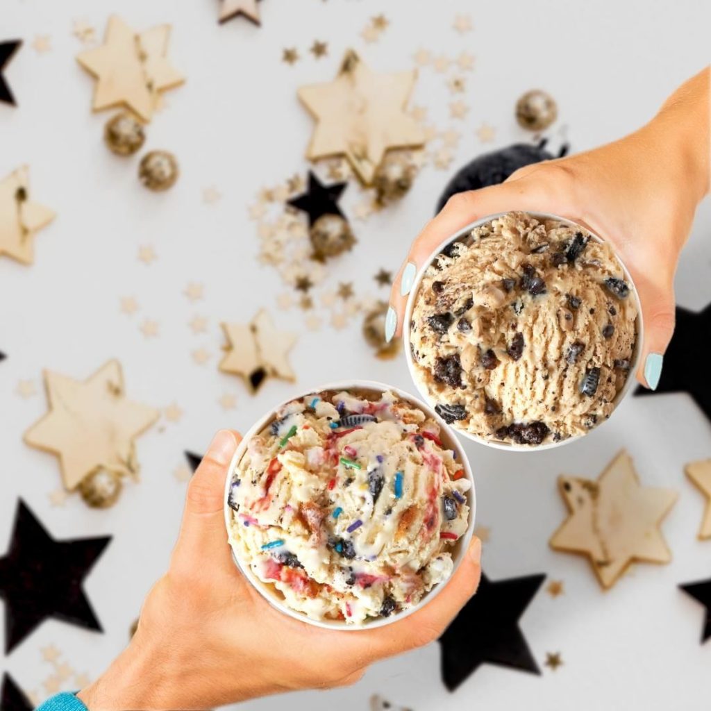 pots of ice cream held by two people